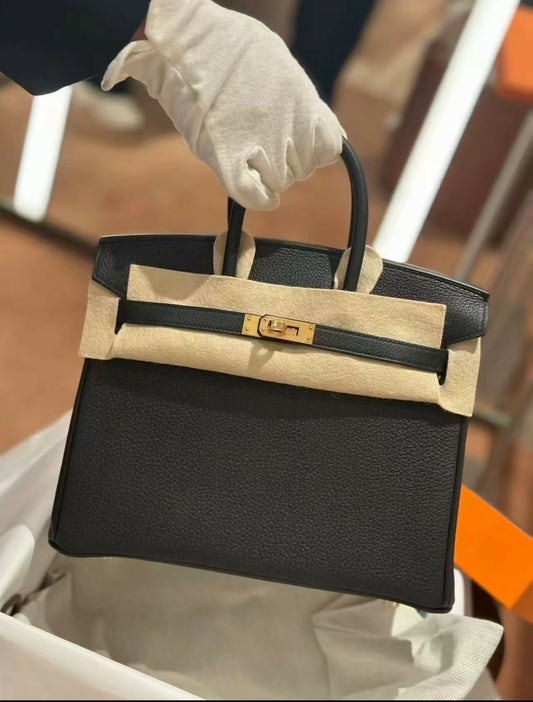 Black Birkin handbag in grained leather with gold hardware, single rolled top handle and turn-lock closure