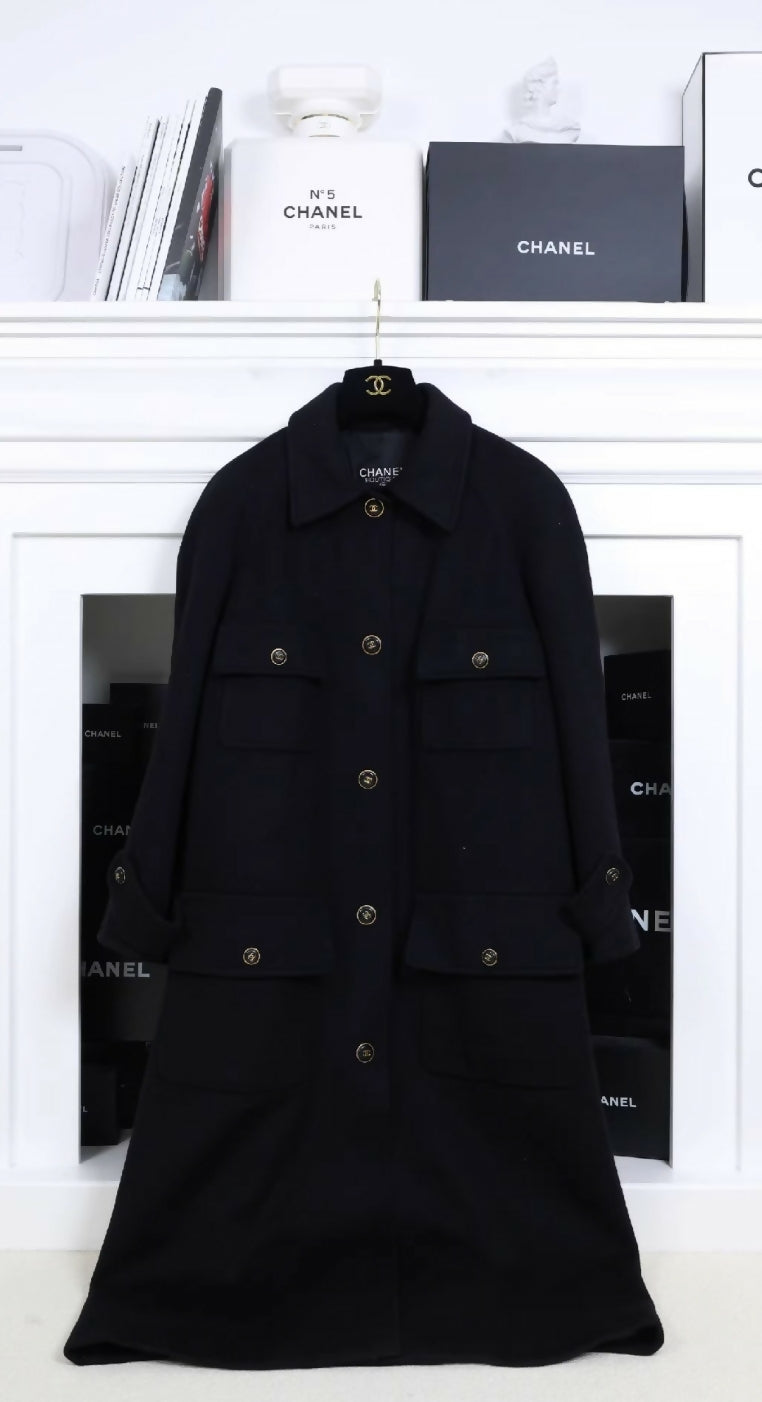 Chanel black woollen coat with black and gold buttons and four pockets.
