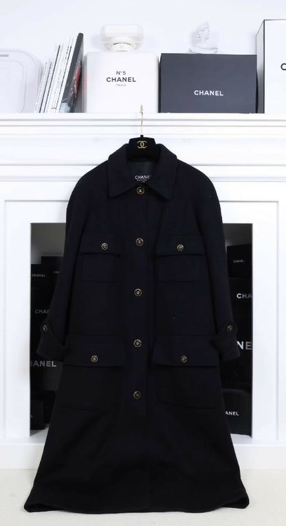 Chanel black woollen coat with black and gold buttons and four pockets.
