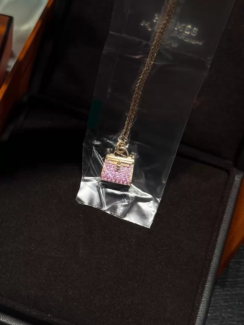 Hermès Kelly bag diamond and pink sapphire pendant necklace