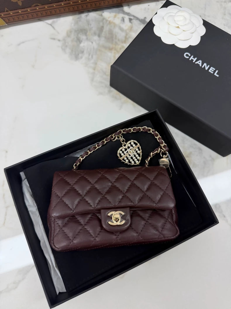 Chanel 25A heart-shaped rhinestone and pearl CF bag key charm.