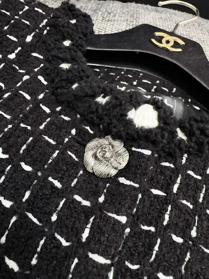 Chanel 23K black tweed jacket with white stitching