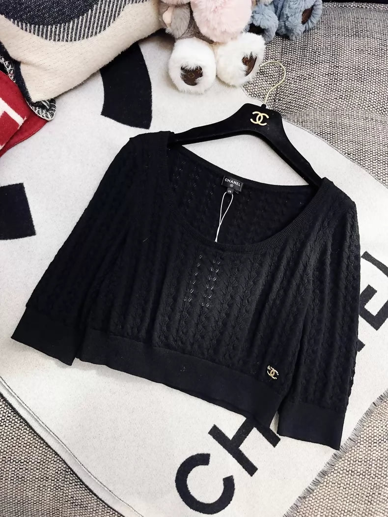 Chanel 24b black floral knit top with a large neckline