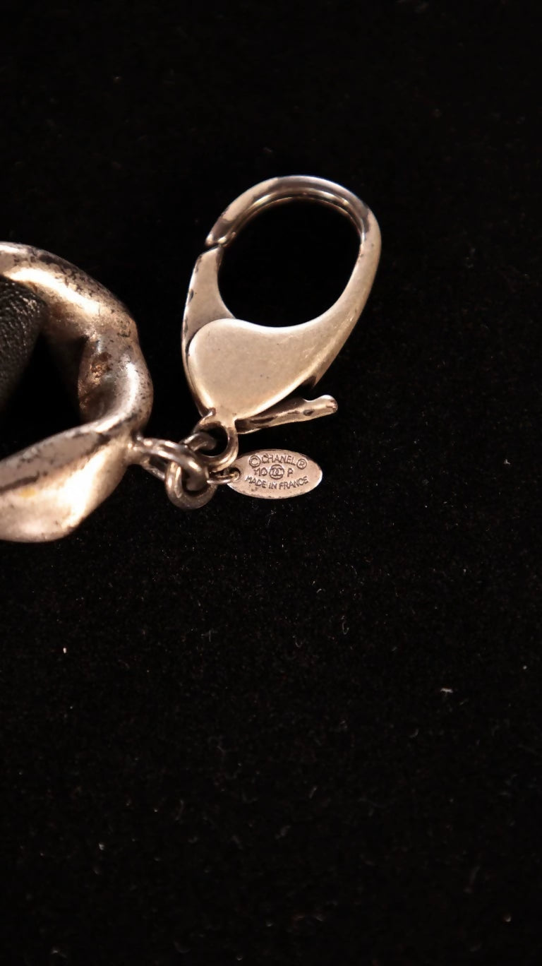 Chanel black and silver leather chain with a rhinestone CC pendant and double waist chain