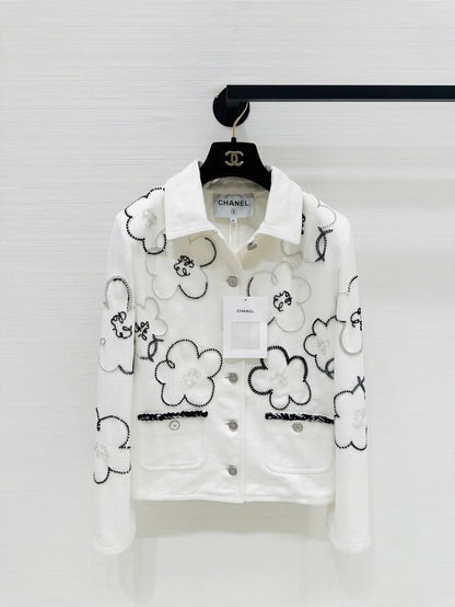 Chanel Métiers d'Art white denim jacket with beaded camellia