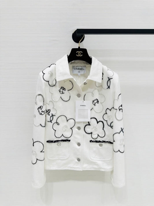 Chanel Métiers d'Art white denim jacket with beaded camellia