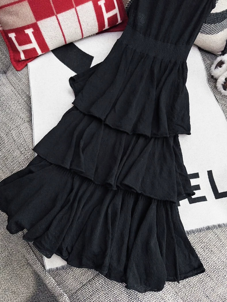 Chanel 25A black dress with camellia brooch