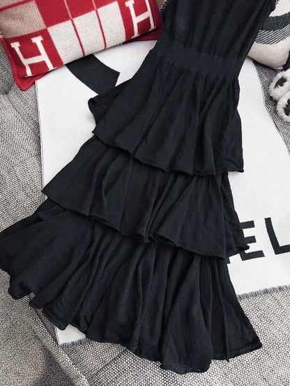 Chanel 25A black dress with camellia brooch