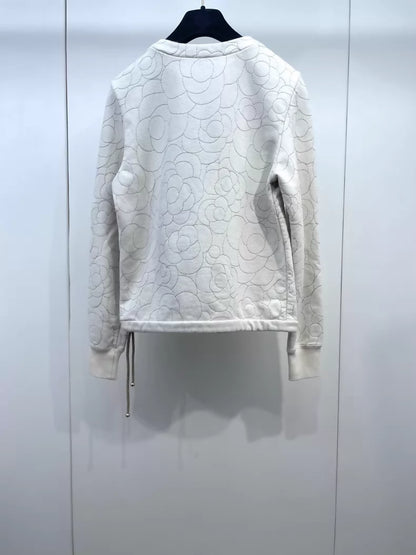 Chanel ecru with gold thread embroidery and camellia buttons on the shoulder