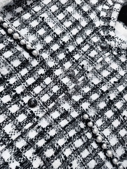Chanel 25P black and white tweed jacket with pearl stitching