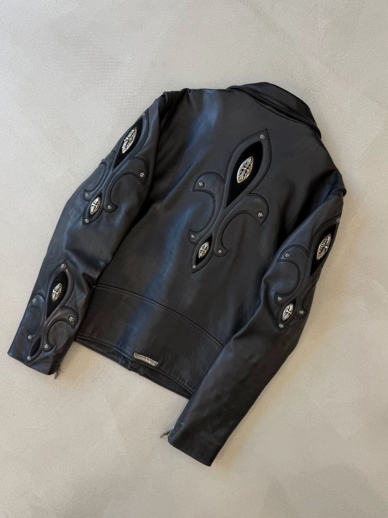 Chrome Hearts leather motorcycle jacket with silver iris embellishments on the arms and back.