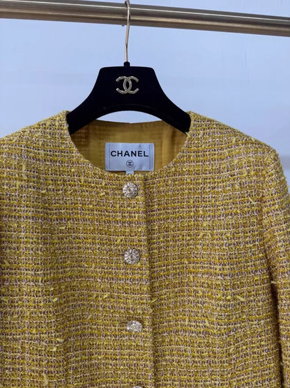 Chanel 23C gold iridescent jacket with black and white checkered sequined pockets and trim