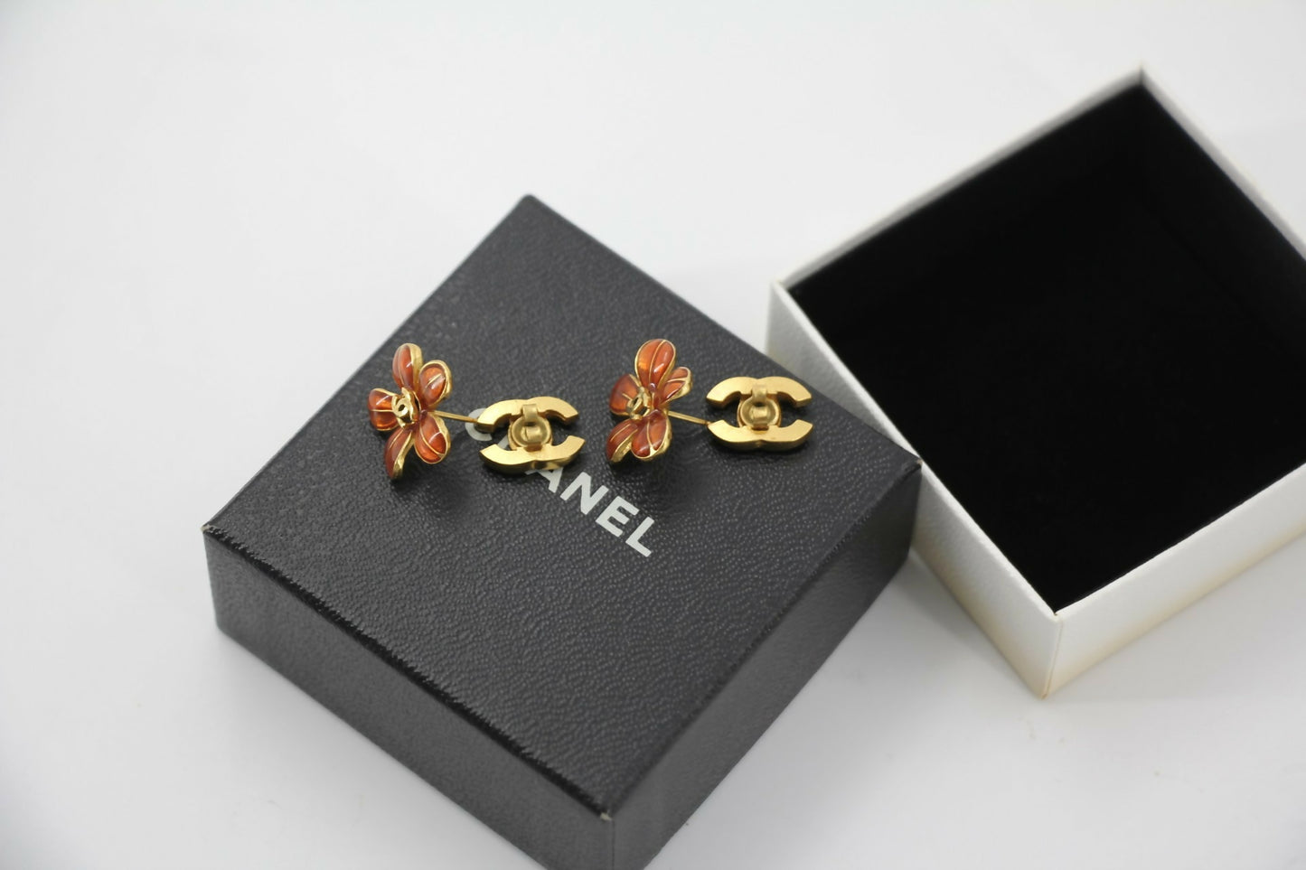 Chanel 03P Enamel Orange Five-Petal Flower Green CC Stacked Earrings
