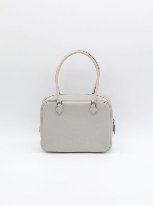 Pale grey leather handbag with two rolled top handles, silver-tone hardware and a side zip