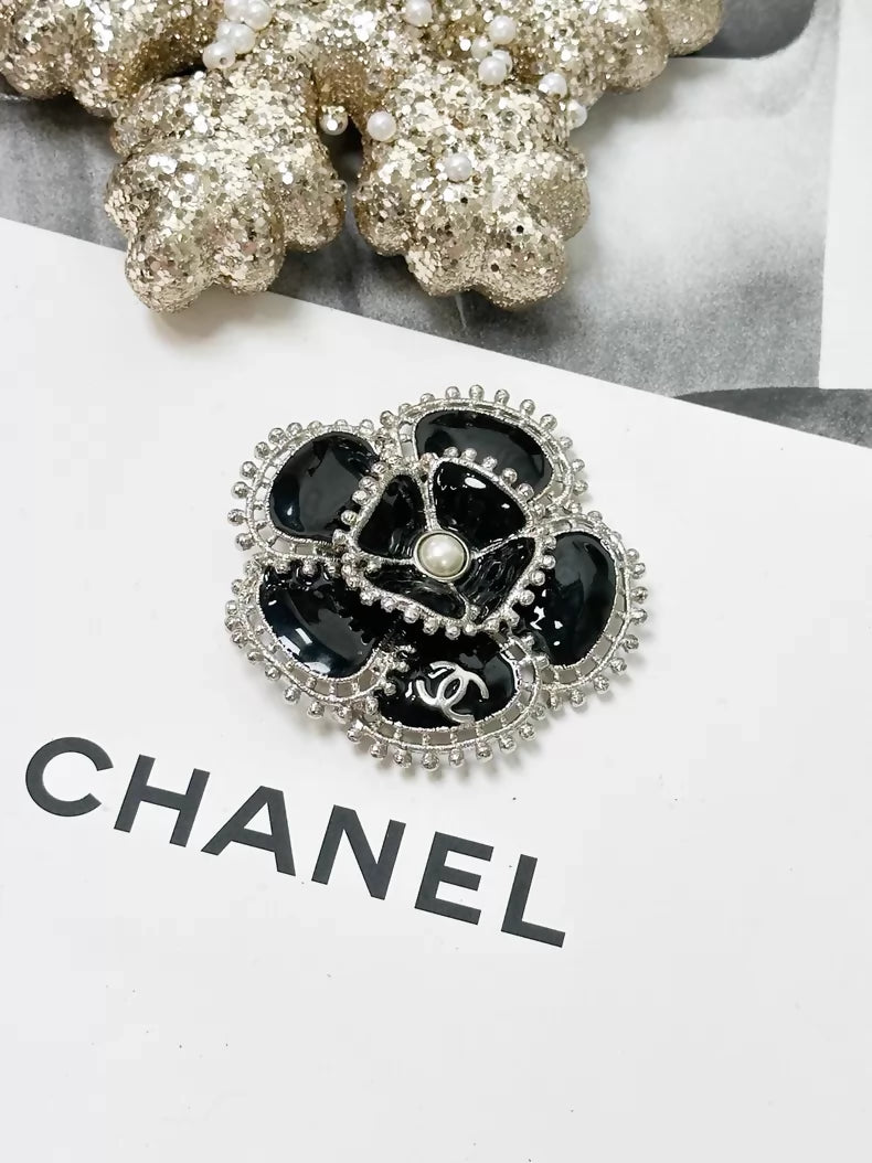 Chanel Fall/Winter 2023 black and silver pearl double C logo camellia brooch