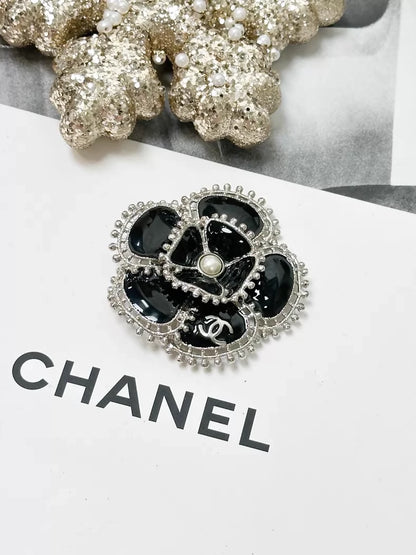 Chanel Fall/Winter 2023 black and silver pearl double C logo camellia brooch