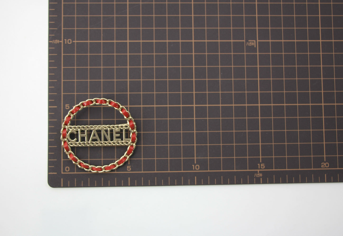 Chanel B18K Leather Red Metal Round Brooch