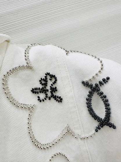 Chanel Métiers d'Art white denim jacket with beaded camellia