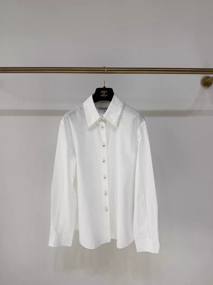 chanel white dress shirt chanelofficial Spring/Summer 2026 RTW is coming!! A first glimpse  introduces us to a crisp white shirt, with classic Chanel script and chain  and pearl details  A true timeless, classic