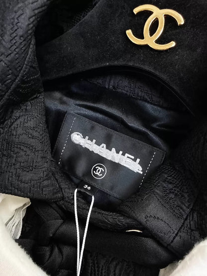 Chanel 21A Black Embossed Long Coat with Ruffled Collar