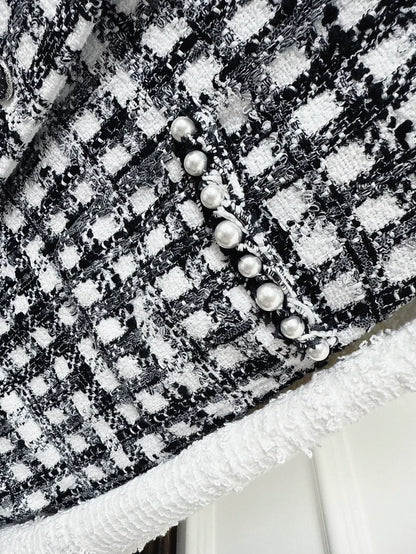 Chanel 25P black and white tweed jacket with pearl stitching
