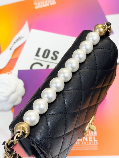 Chanel, black quilted pearl-trimmed vertical chain bag,