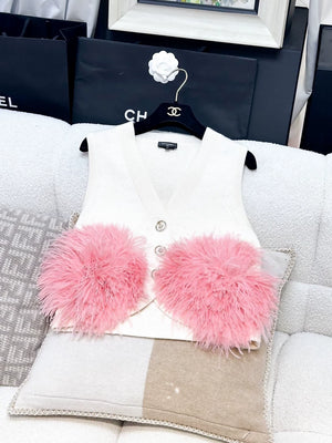 Chanel Fall/Winter 2023, white cashmere vest with pink ostrich feather