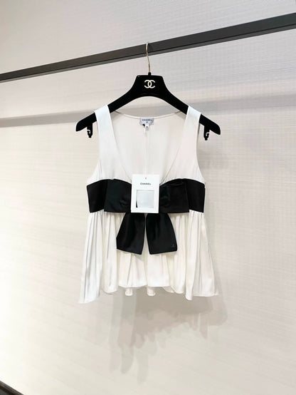 Chanel 25K black and white silk top with bow.