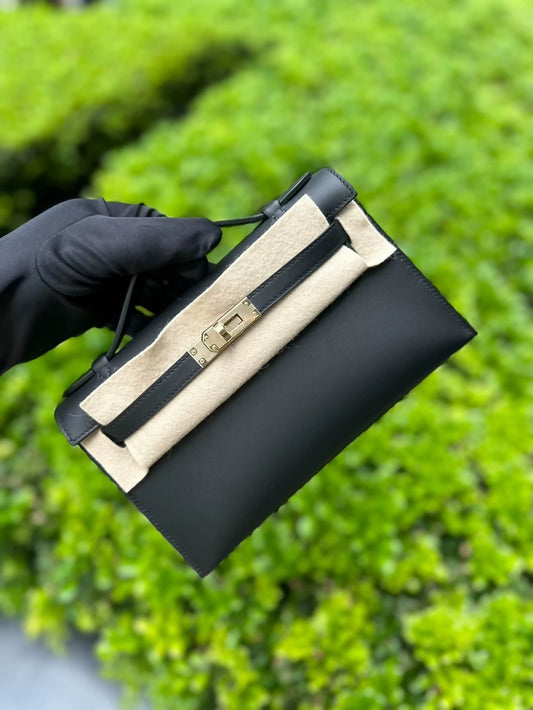 Hermès Kelly pochette black swift leather with light gold hardware