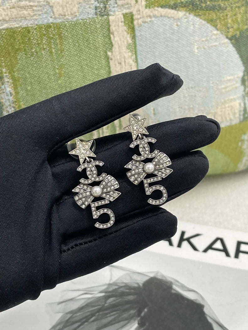 Chanel multi-element star and bow earrings