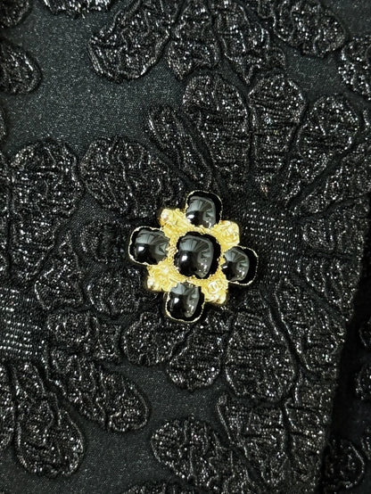 Chanel 21A black embossed camellia off-the-shoulder tweed jacket
