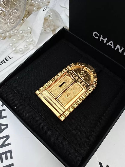 Chanel gold brooch with "31 Rue Cambon"