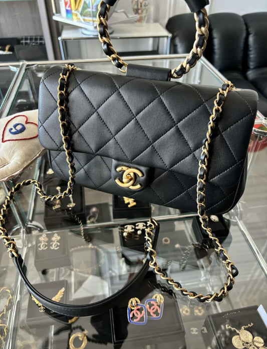 CHANEL Chanel Circular Handle Flap Bag Black Lambskin Aged Gold Hardware - Medium Crossbody Bag - Secondhand luxury from Wararni