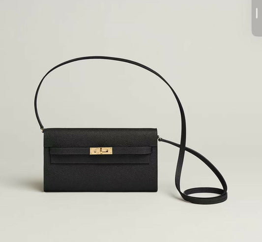 Black textured leather flap shoulder bag with gold-tone turn-lock and thin long strap