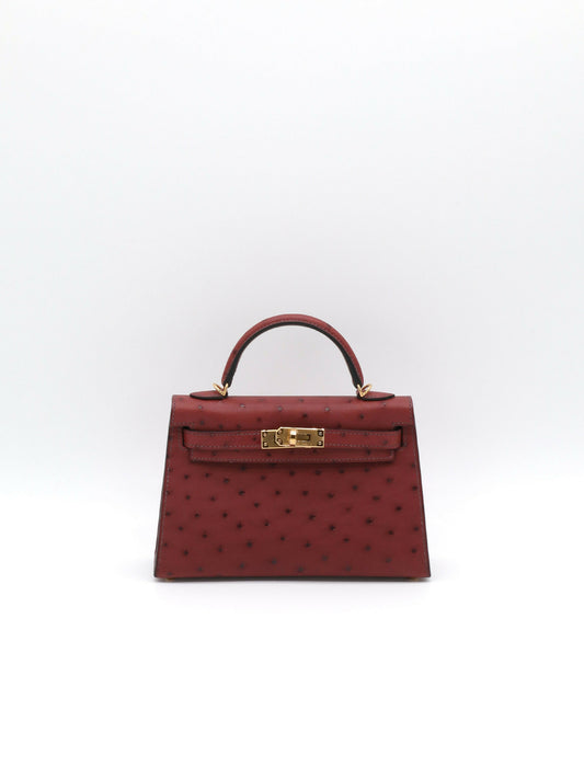 Mini Kelly handbag in burgundy ostrich leather with gold-tone hardware, single top handle and turn-lock closure