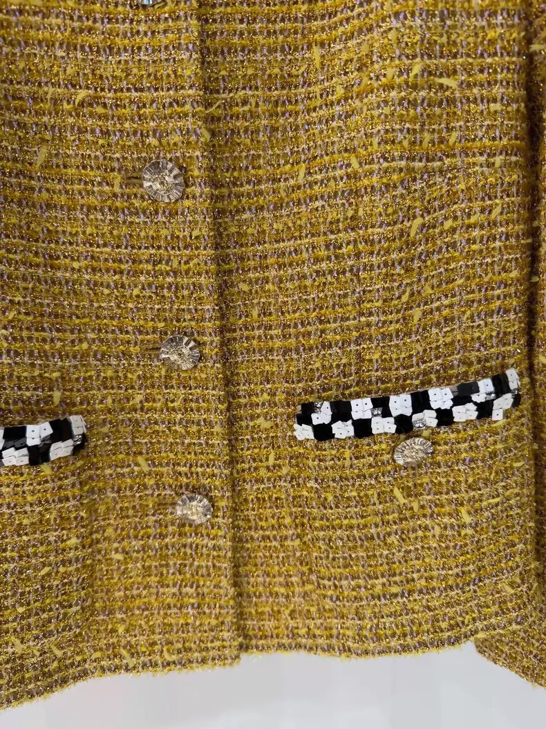 Chanel 23C gold iridescent jacket with black and white checkered sequined pockets and trim