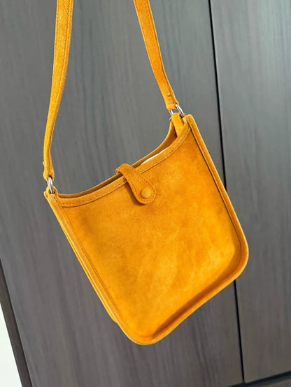 The Hermès Evelyen mini bag in turmeric orange suede is extremely rare!