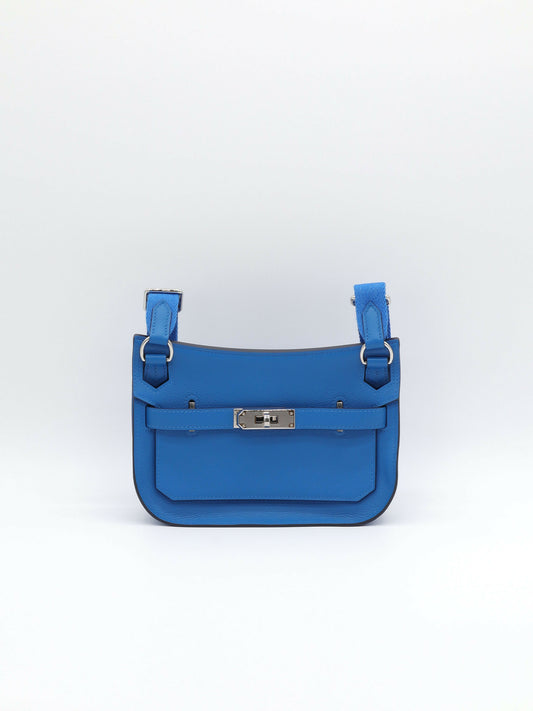 Blue leather crossbody bag with palladium turn-lock, front belt strap and woven blue canvas shoulder strap
