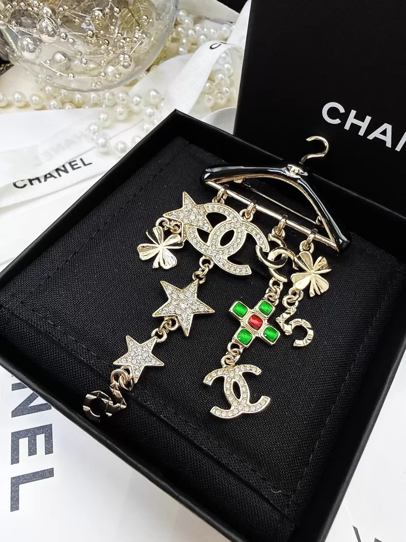 Chanel 23C black and gold hanger brooch
