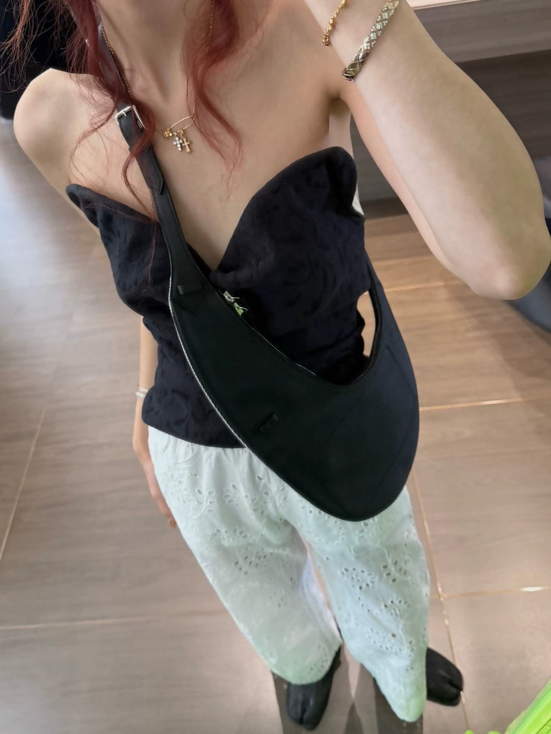 Hermès reversible black and silver clutch presented on the catwalk in 2023