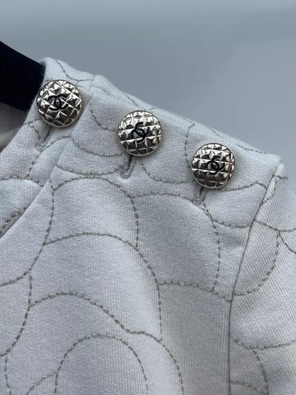 Chanel ecru with gold thread embroidery and camellia buttons on the shoulder