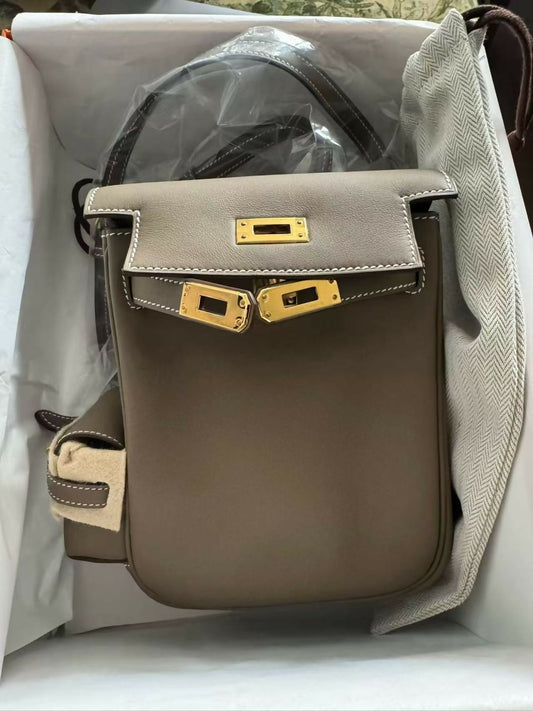 Hermès Kelly Pocket-style crossbody bag in taupe leather with gold-tone hardware and contrast white stitching