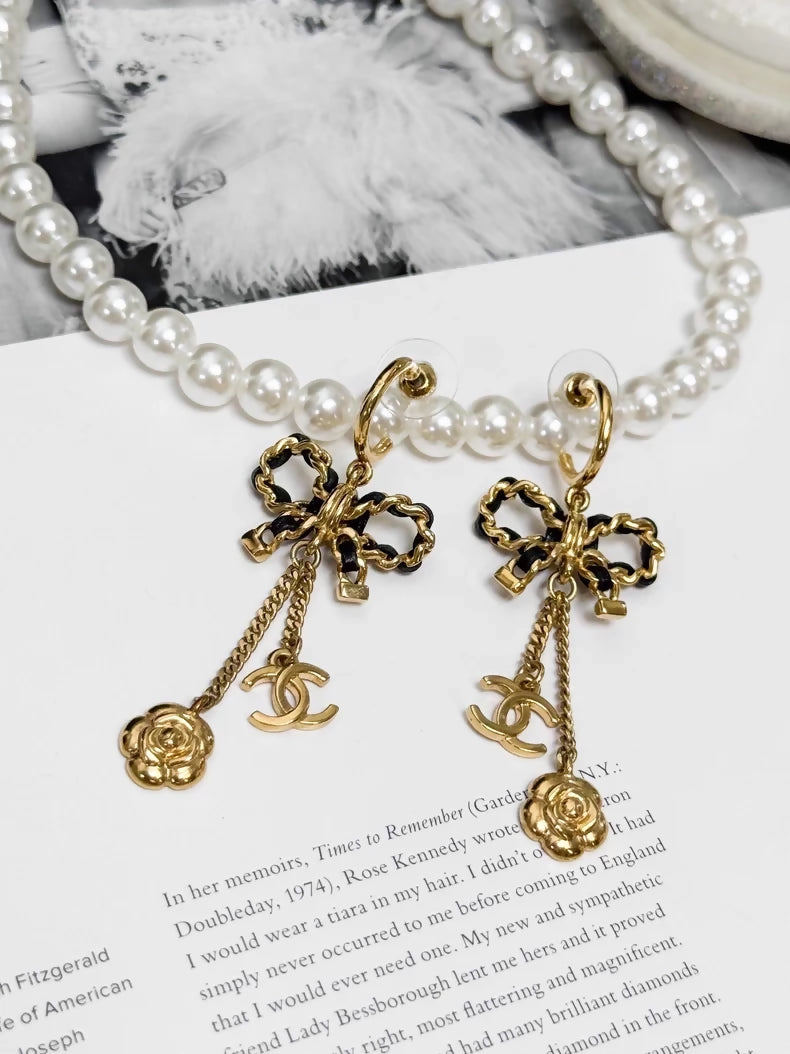 Chanel Métiers d'Art black and gold leather chain with bow earrings