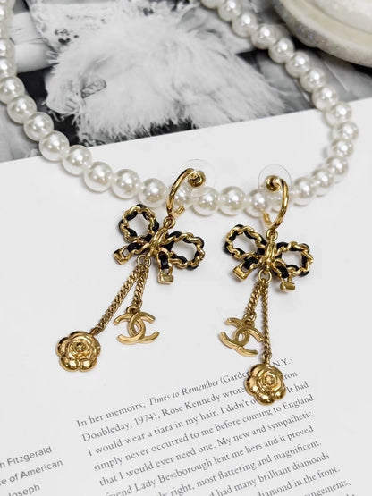 Chanel Métiers d'Art black and gold leather chain with bow earrings