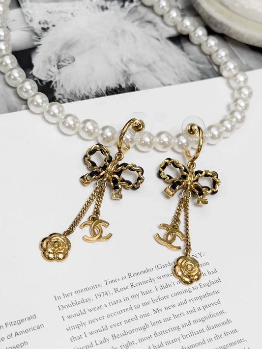 Chanel Métiers d'Art black and gold leather chain with bow earrings