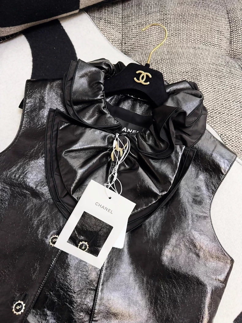 Chanel 25K black leather vest with bow and ruffled collar