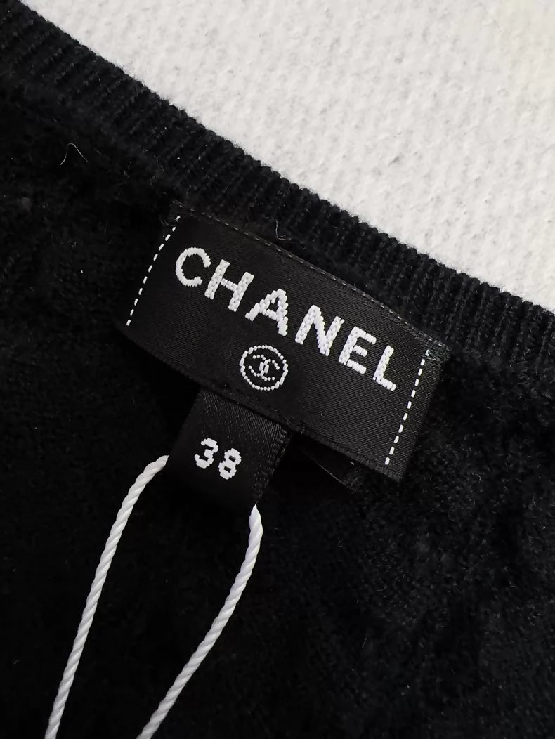 Chanel 24b black floral knit top with a large neckline