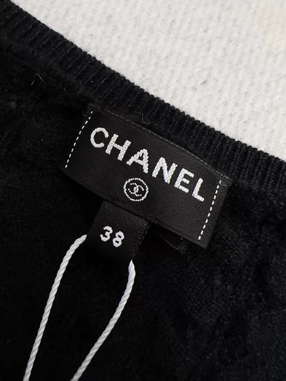 Chanel 24b black floral knit top with a large neckline