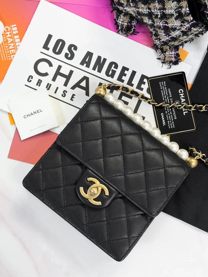 Chanel, black quilted pearl-trimmed vertical chain bag,