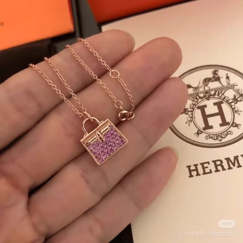 Hermès Kelly bag diamond and pink sapphire pendant necklace